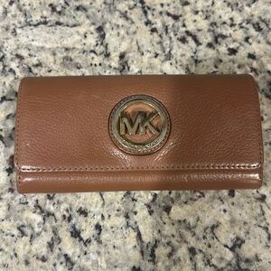 Michael Kors tan leather wallet. Emblem is slightly tarnished but in great shape